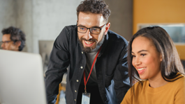 two people looking at a computer smiling
